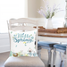 Blue hello spring pillow on dining chair