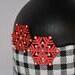 Close up of red snowflakes Handcrafted Red, Black, and White Christmas Wine Bottle Gnome