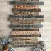 Extra large wall decoration. This is a collection of eleven reclaimed wood boards hanging together on the wall. Each board has a different family rule or phrase. The decorative lettering is wood-burned by hand.
