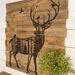 This image shows a deer silhouette wood burned onto an old fence. It is a large square statement piece for a rustic home. 