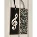 Glossy black and silver metallic combineto make a Treble Clef  double sized bookmark. Made of cardstock and laminated 
Measurents: 2.25" W x 6:" L