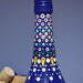 Hand painted blue bottle with various dot art/mandala designs around the entire bottle