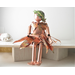 marionette aka string puppet made of copper, sitting down.