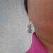 Earring worn on a person to show its relative size when worn. Reaches the jaw bone on this person.