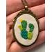Embroidery pendant with prickly pear design