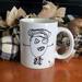 Coffee mug with funny kids stick figure artwork.