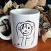 mug with kid stick figure of a girl.