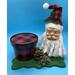 A fun holiday tray for all the guests for the holidays,  Santa in full facial makeup and pine cones by bottom of his beard.  The green base is ascalloped  design.  We added red buffalo plaid container which may hold candy and is reuseable.