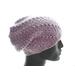The slouchy beanie has a flattering drape in back, and the stitches form diagonal lines from the brim to the crown.