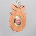 A handmade wood photo ornament featuring a hand-cut design and a customizable photo insert.