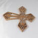 This Ten-Inch Rustic Fretwork Christian Cross Wall Hanging Art is handcrafted from reclaimed wood. Its intricate fretwork design adds unique texture and character, blending rustic charm with elegant design. It is a perfect focal point for any room.