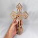 This Ten-Inch Rustic Fretwork Christian Cross Wall Hanging Art is handcrafted from reclaimed wood. Its intricate fretwork design adds unique texture and character, blending rustic charm with elegant design. It is a perfect focal point for any room.