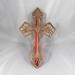 This Ten-Inch Rustic Fretwork Christian Cross Wall Hanging Art is handcrafted from reclaimed wood. Its intricate fretwork design adds unique texture and character, blending rustic charm with elegant design. It is a perfect focal point for any room.