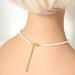Back view of minimalist pearl choker, shown on a mannequin.