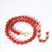 Hand knotted red faceted glass beaded choker necklace, with adjustable extender chain.