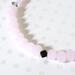 Pink pastel faceted glass beads, with a black crystal accent.