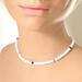 Minimalist pink glass beaded choker, shown on a mannequin.
