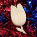 A wooden miniature birdhouse Christmas tree ornament shaped like a tulip, made from light beige wood, with a small dark reddish-brown bird perched at the entrance. It features a gold-colored hanging loop on top.