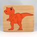 Handmade Wood Dinosaur Tray Puzzle with Amber Shellac and Orange Paint Finish. Freestanding and Versatile Toy for Kids of All Ages, Crafted in the USA with Traditional Woodworking Tools.