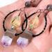 Amethyst, quartz and labradorite earrings, shown in hand, for size comparison.