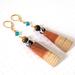 Wood, clay, blue crystal and tigereye dangle earrings, with gold plated lever back ear wires.