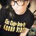 Black t-shirt on bigger, tattooed model.  The shirt image is Olde English lettering on top of large block letters reading "Thicc Thighs - Pretty Eyes, Aggro Vibes in Goldenrod Yellow vinyl .