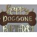 Happy Doggone Birthday Cake topper in metallic gold with a brown dog bone.