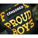 Black t-shirt on bigger, tattooed model showing just the image/torso.  The image  is in Goldenrod Yellow and feature a bold, Traditional style font with the saying of "F*** PROUD BOYS" in all caps with a distressed laurel wreath as the U.