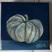 Photo of small square canvas painting of oddly shaped light blue pumpkin with a dark blue background