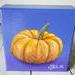 Photo of small square canvas painting of orange pumpkin with purple blue background