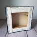 Photo of back of small square canvas