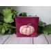 Photo of small square canvas painting of peach colored pumpkin with a raspberry pink background
