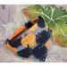 Closeup of Pumpkin Patch Bandana on a cat breakaway color sitting on fall background leaves.