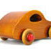 Handmade 1957 Bug Wood Toy Car from My Play Pal Collection, crafted with traditional woodworking tools and finished with amber shellac and bright red trim. Each toy is meticulously assembled and tested for the highest quality.