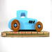 This handmade wooden toy car, modeled after a 1927 Ford T-Coupe, is hand-painted baby blue with black and metallic sapphire blue. The wheels are finished with nonmarring amber shellac.