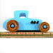 This handmade wooden toy car, modeled after a 1927 Ford T-Coupe, is hand-painted baby blue with black and metallic sapphire blue. The wheels are finished with nonmarring amber shellac.