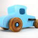 This handmade wooden toy car, modeled after a 1927 Ford T-Coupe, is hand-painted baby blue with black and metallic sapphire blue. The wheels are finished with nonmarring amber shellac.