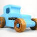This handmade wooden toy car, modeled after a 1927 Ford T-Coupe, is hand-painted baby blue with black and metallic sapphire blue. The wheels are finished with nonmarring amber shellac.