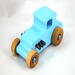 This handmade wooden toy car, modeled after a 1927 Ford T-Coupe, is hand-painted baby blue with black and metallic sapphire blue. The wheels are finished with nonmarring amber shellac.