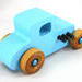 This handmade wooden toy car, modeled after a 1927 Ford T-Coupe, is hand-painted baby blue with black and metallic sapphire blue. The wheels are finished with nonmarring amber shellac.