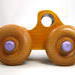 Handmade wood toy monster pickup truck from the Play Pal Collection, featuring a stunning finish of amber shellac and metallic purple trim. Crafted in the USA using traditional woodworking tools and techniques, this eye-catching toy truck is built to last.


Carefully assembled and tested for the highest quality, it's designed for kids to play with. The large wheels ensure smooth rolling on various surfaces, and its sturdy build can withstand rough play, making it a durable and enjoyable addition to any child's collection.