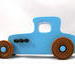 Handmade wooden toy car modeled after a '27 T-Coupe, finished with baby blue and black acrylic paint with nonmarring amber shellac wheels from my hot rod collection.