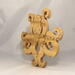A handcrafted octopus puzzle made from wood. The puzzle is freestanding and can comfortably sit on a shelf, table, window sill, or door frame.