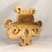 A handcrafted octopus puzzle made from wood. The puzzle is freestanding and can comfortably sit on a shelf, table, window sill, or door frame.