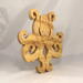 A handcrafted octopus puzzle made from wood. The puzzle is freestanding and can comfortably sit on a shelf, table, window sill, or door frame.