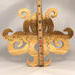 A handcrafted octopus puzzle made from wood. The puzzle is freestanding and can comfortably sit on a shelf, table, window sill, or door frame.