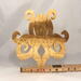A handcrafted octopus puzzle made from wood. The puzzle is freestanding and can comfortably sit on a shelf, table, window sill, or door frame.