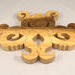 A handcrafted octopus puzzle made from wood. The puzzle is freestanding and can comfortably sit on a shelf, table, window sill, or door frame.