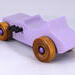 This toy is a beautifully crafted wooden toy car in a '27 T-Bucket Hot Rod style. The car has been painted with a high gloss lavender finish and features black acrylic paint trim. The wheels are non-marring and have an amber shellac finish.