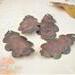 grouping of three pairs of large copper oak leaf earrings